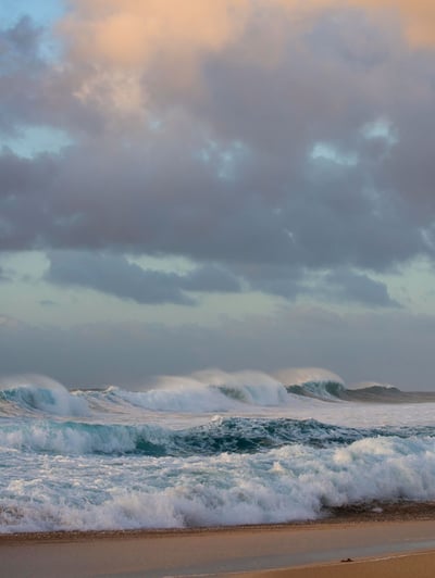 Waves crashing on the beach in Oahu, Hawaii.