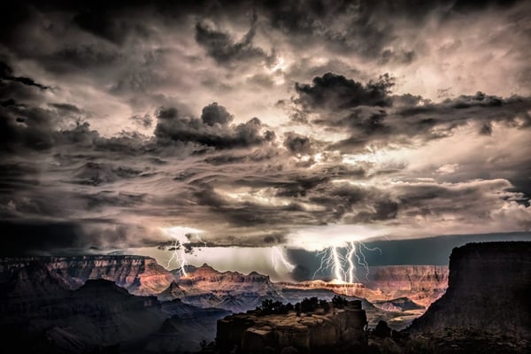 Shot this image at Morna Point in the Grand Canyon on August 30th, 2013. I was there with my girlfriend and my friend Rolf Maeder, and told them I wanted to stay after dark to hopefully get lucky enough to capture lightning over the Grand Canyon. This was my biggest wish in the world as living in Sedona for the past 2 years, I had been teaching people how to shoot lightning and Rolf and my girlfriend were very excited too. When I saw the first bolt, I screamed to both of them to get their cameras and I lightpainted the foreground for both of them and stayed there for hours shooting that amazing night. This is a single shot where i was able to get three different lightning bolts. I post processed it in raw and used Nik Color Efex to bring out more detail.
